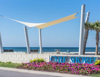 Gulf shores beach with sign and shade cover