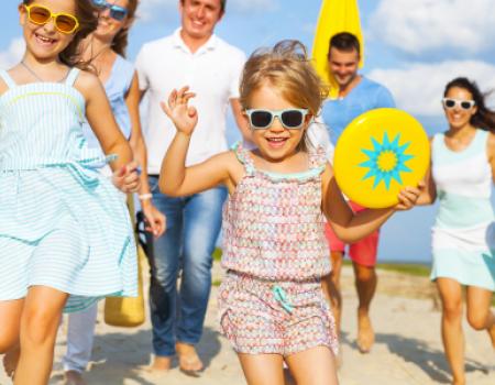 family heading to the beach with beach toys