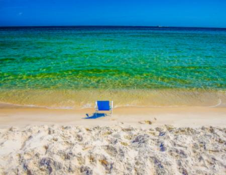 orange beach alabama, blue beach chair in front of waves orange beach 