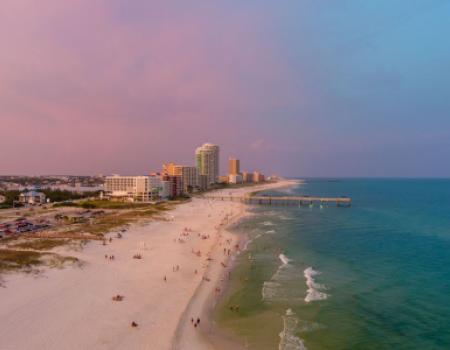 sunset aerial shot of beach in orange beach, alabama