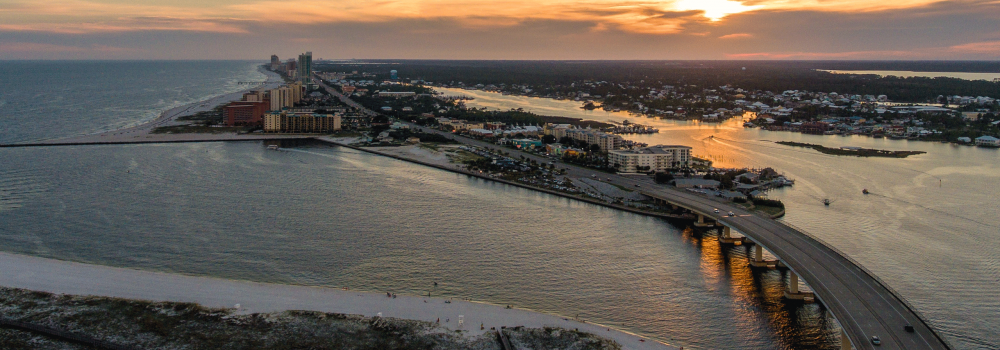 Aerial view of the Alabama Gulf Coast beach and Perdido Pass at sunset